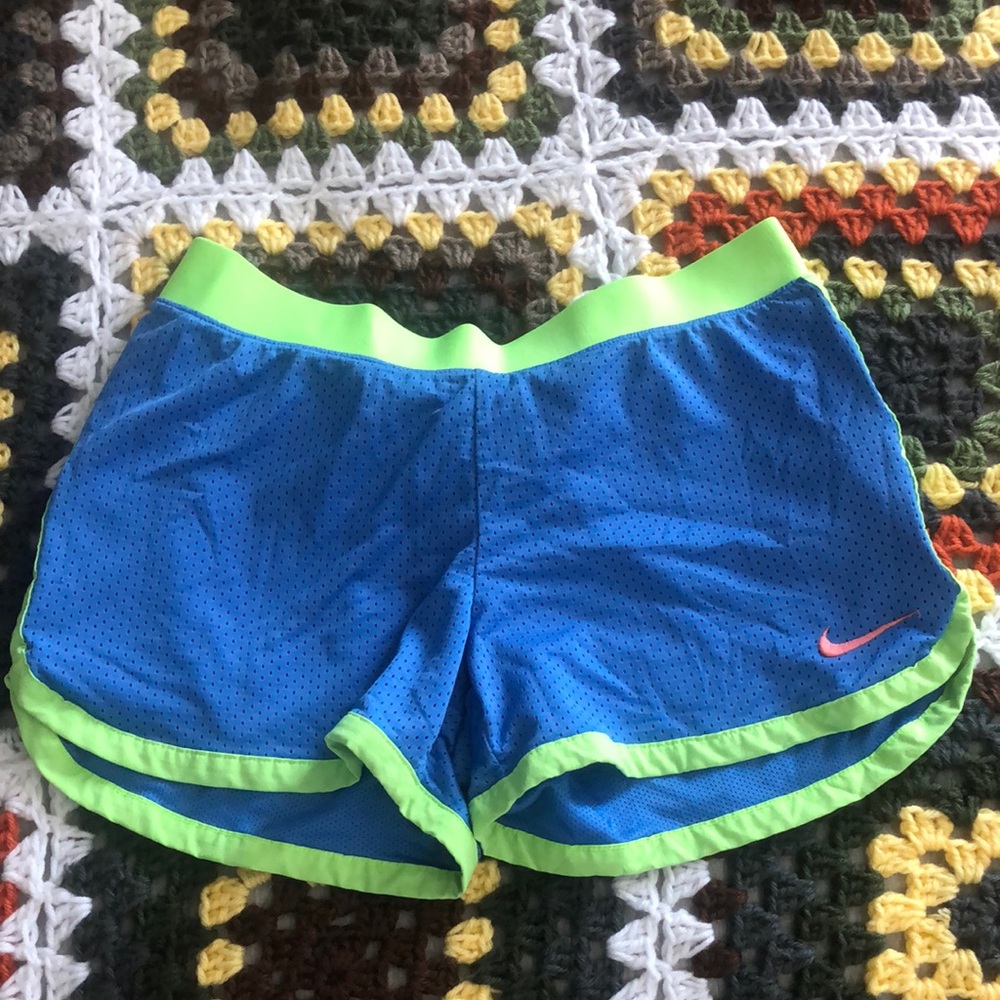 Small Nike shorts. Neon blue and green.